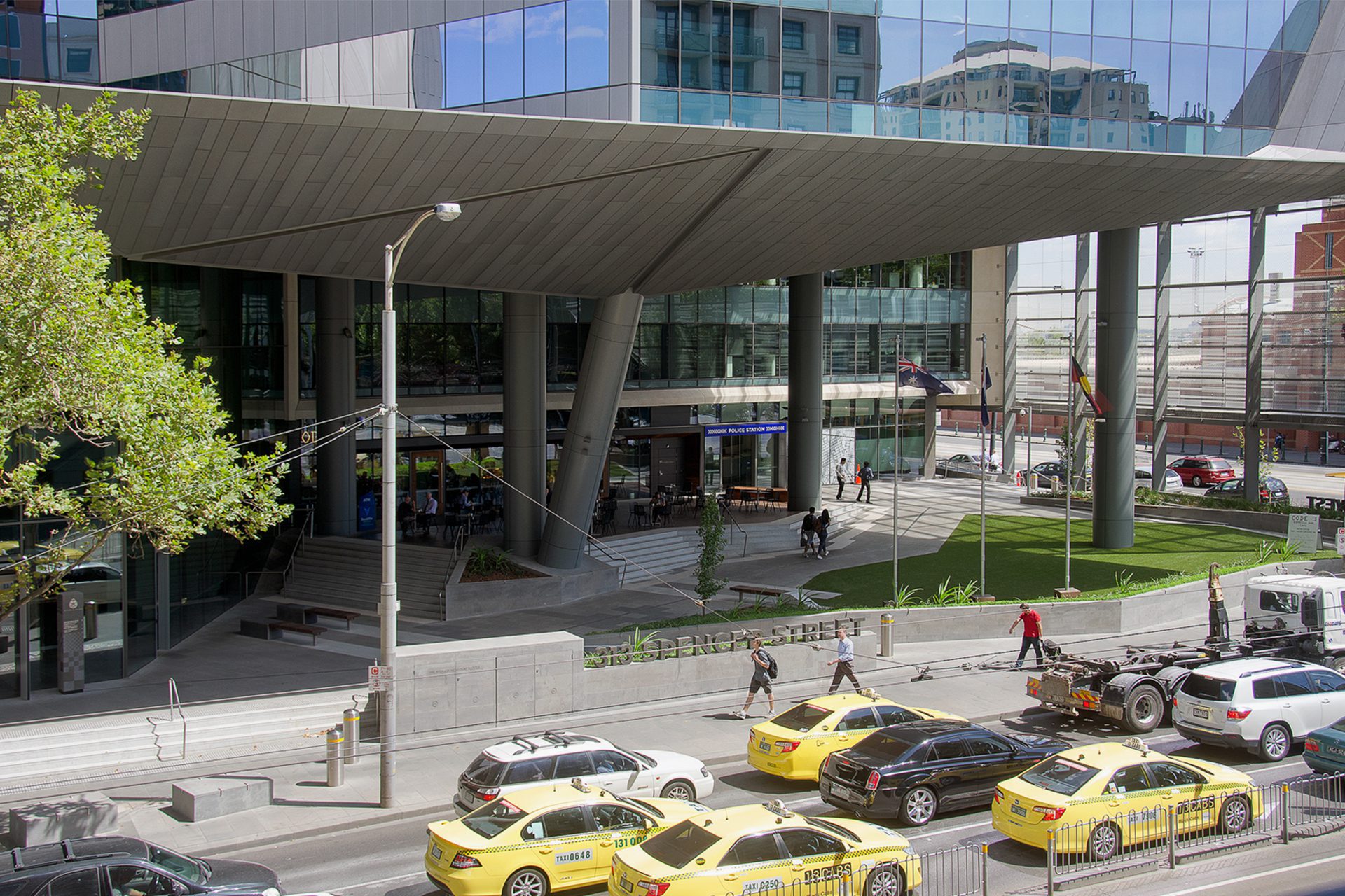 Svg+xml;charset=utf — tract Elevated view of the front of the city west police building on a busy day