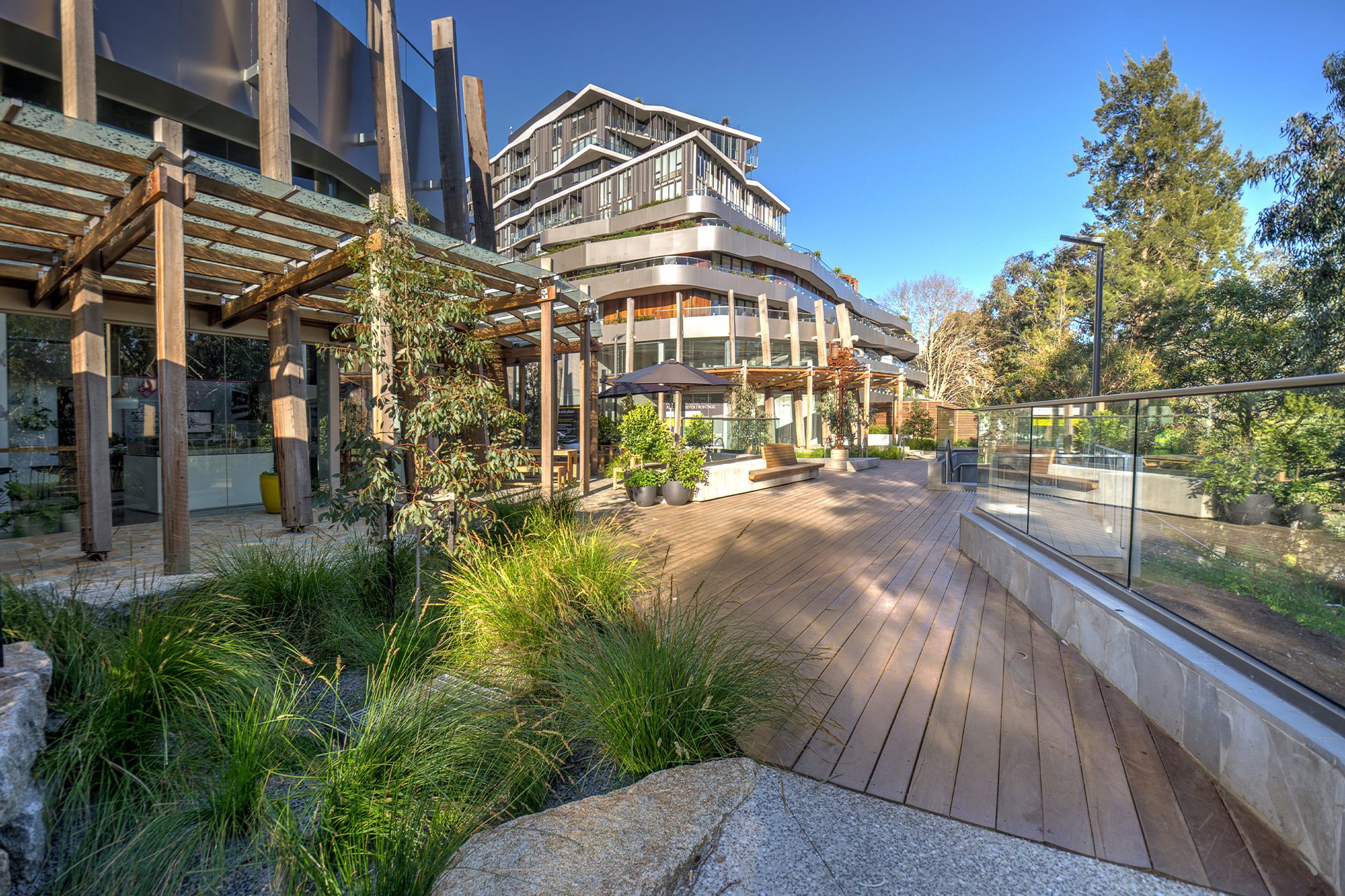 Svg+xml;charset=utf — tract Acacia place communal area with timber decking and native planting