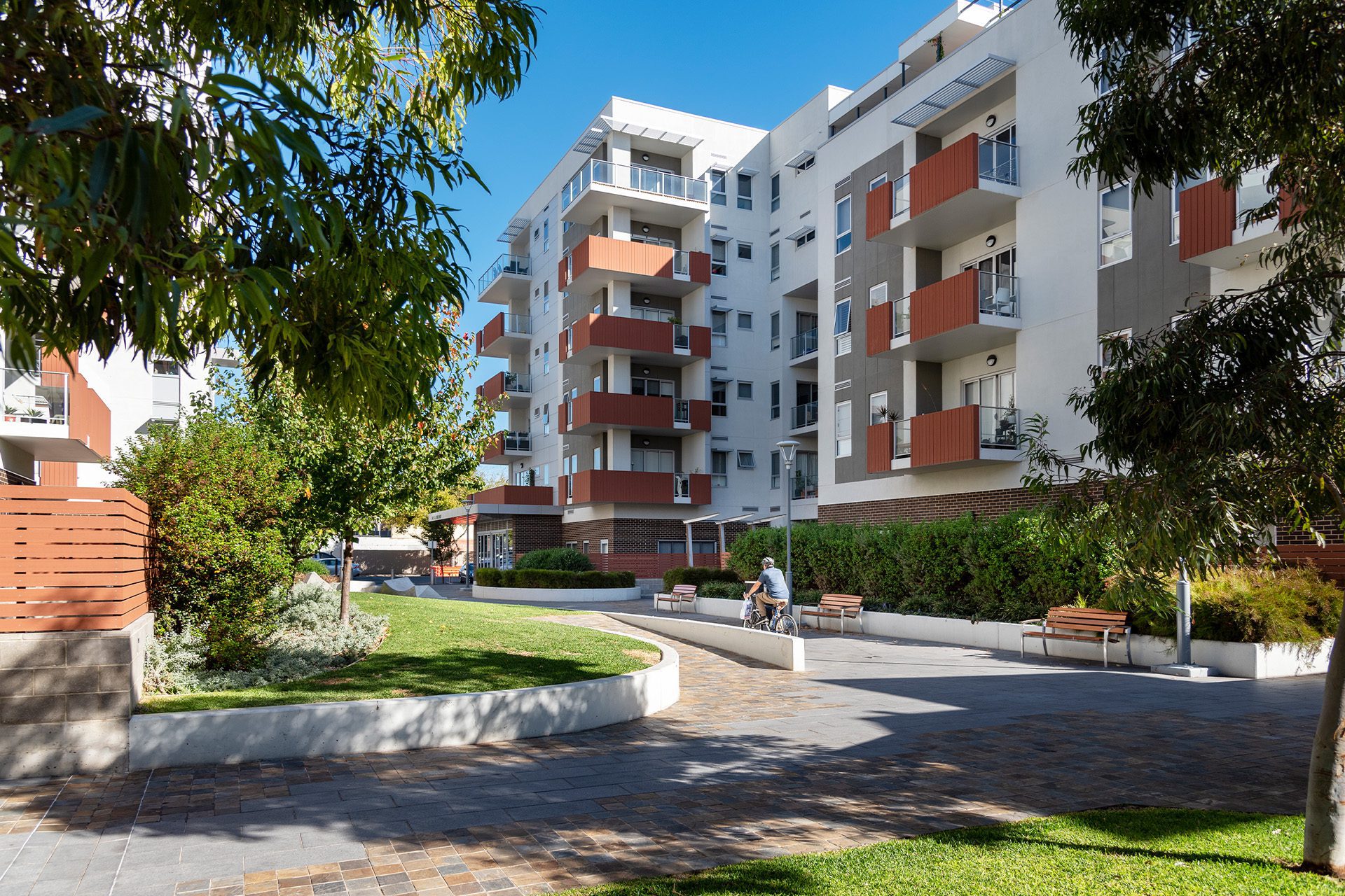 Paved pathways and garden landscape in front of Ergo Apartments